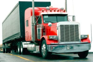 Image of a red semi truck featuring the Datamasters logo and highlighting DataMasters Semi Truck Owners and Trucking Fleets, ensuring it aligns with the page's context on targeted logistics data.