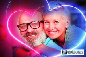 Purple and blue background image with a male and female senior citizen in embrace.